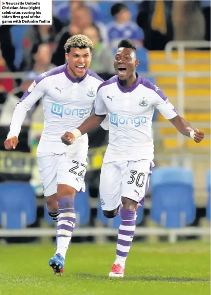  ??  ?? > Newcastle United’s Christian Atsu (right) celebrates scoring his side’s first goal of the game with DeAndre Yedlin