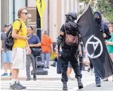  ?? SIPA USA ?? Members of Antifa march before a “Unite the Right” rally in Washington, D.C., in August.