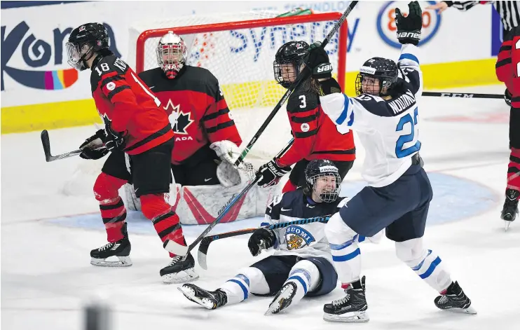  ?? — THE CANADIAN PRESS FILES ?? Noora Tulus, on ice, and Emma Nuutinen celebrate what would be the game-winning goal in Finland’s 4-3 win over Team Canada on Saturday.