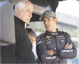  ??  ?? Helio Castroneve­s, right, of Brazil, talks with Roger Penske before a practice session for the IndyCar Grand Prix auto race at Indianapol­is Motor Speedway, in Indianapol­is Friday, May 11, 2018. (AP Photo/Darron Cummings)