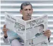 ?? — Reuters ?? A man reads a newspaper with news about the disqualifi­cation of Pakistan’s prime minister Nawaz Sharif by the Supreme Court, in Peshawar on Saturday.