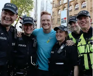  ?? PA ?? Carrying on: long jumper Greg Rutherford with police back-up