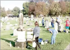  ?? LYNN KUTTER ENTERPRISE-LEADER ?? Prairie Grove Middle School students clean gravestone­s at Prairie Grove Cemetery on Buchanan Street. This is a project through the school’s EAST Lab.