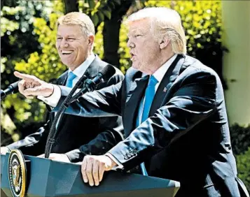  ?? SUSAN WALSH/ASSOCIATED PRESS ?? President Donald Trump punches back at former FBI chief James Comey’s testimony during a Rose Garden news briefing Friday with Romanian President Klaus Iohannis. Trump said he is willing to testify in the government’s Russia probe.