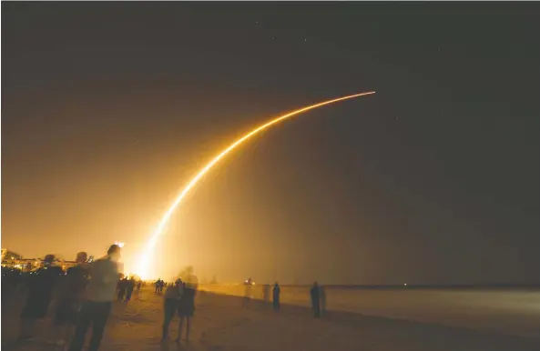  ?? GETTY IMAGES ?? Spectators gather on the beach in 2018 to watch a Space X launch from Cape Canaveral Air Force Station in Florida.