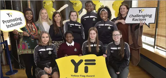  ??  ?? Minister for Children and Youth Affairs, Katherine Zappone congratula­tes St Oliver’s CC for reaching Anti-Racism and Inclusion Targets at Yellow Flag Awards