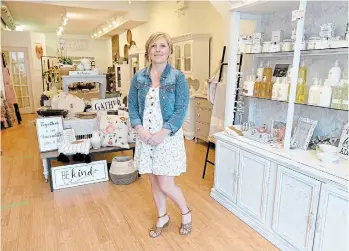  ?? CATHIE COWARD THE HAMILTON SPECTATOR ?? Aimee Cline is just opening her shop, Vintage Charm, on Locke Street, having moved from James Street North. Tape on the floor and at the counter and limiting the number of people inside at one time help keep shoppers safe.