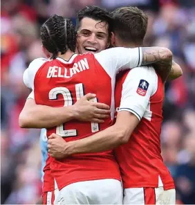  ?? Photo: AFP ?? Arsenal’s Spanish defender Hector Bellerin (L), midfielder Granit Xhaka (C) and midfielder Aaron Ramsey celebrate victory after the FA Cup semi-final football match between Arsenal and Manchester City at Wembley stadium in London yesterday.