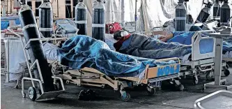  ?? AFP ?? PATIENTS were treated for Covid-19 in a temporary ward at Steve Biko Academic Hospital, in Preotoria, last year. The pandemic complicate­s issues, exposing the fragility of many health systems’ preparedne­ss in responding to epidemic outbreaks, says the writer. |