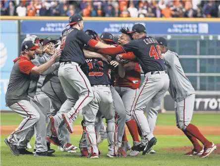  ??  ?? Nationals players celebrate on the field after defeating the Astros in Game 7 of the 2019 World Series. TROY TAORMINA/ USA TODAY SPORTS