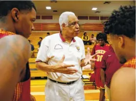  ?? STAFF PHOTO BY DOUG STRICKLAND/TIMES FREE PRESS ?? Longtime Howard boys’ basketball coach Walter McGary talks with his team before Friday’s district tournament quarterfin­al against East Ridge. Howard won 55-50.