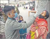  ?? ANI ?? A health care worker collects nasal sample from passenger for Covid-19 test at Patna Railway station, in Patna on Thursday.