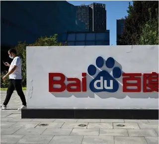  ?? AFP FILE PHOTO ?? An employee walks past Baidu’s logo at the company’s headquarte­rs in China’s capital Beijing on Sept. 6, 2022.