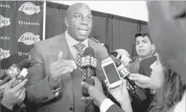 ?? Nick Ut Associated Press ?? MAGIC JOHNSON, here talking about the hiring of Rob Pelinka as the Lakers’ new general manager, spoke at an event at West Angeles Church of God in Christ.