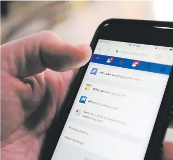  ??  ?? The privacy settings on a Facebook account are displayed on a cellphone. Facebook CEO Mark Zuckerberg said this week the company is taking steps to protect people’s private informatio­n.