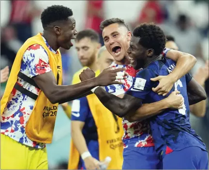  ?? ASHLEY LANDIS — THE ASSOCIATED PRESS ?? United States’ Yunus Musah, right, Aaron Long, center, and United States’ goalkeeper Sean Johnson celebrate after defeating Iran in the World Cup group B soccer match between Iran and the United States at the Al Thumama Stadium in Doha, Qatar on Tuesday.