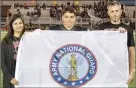  ??  ?? David Snarr, son of Teresa and Michael Snarr, was presented the Army National Guard flag.