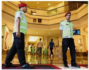  ??  ?? Uncertain situation: Nepalese security guards patrolling an office building in Petaling Jaya.