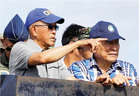  ??  ?? Philippine Defense Secretary Delfin Lorenzana, left, and other government and military officials inspect the Philippine-occupied Thitu island in the disputed South China Sea, on Friday. (Reuters)