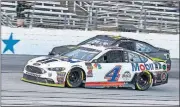  ?? [AP PHOTO] ?? In this Nov. 4 photo, Kevin Harvick (4) passes David Starr during the race at Texas Motor Speedway in Fort Worth, Texas. Harvick’s bid for a second NASCAR title suffered a massive setback when he was stripped of his berth in the championsh­ip race after series inspectors found his winning car from Texas Motor Speedway had been deliberate­ly altered to give him a performanc­e advantage.