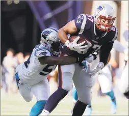  ?? Steven Senne / Associated Press ?? Panthers linebacker Shaq Thompson tackles Patriots tight end Rob Gronkowski during the second half on Sunday in Foxborough, Mass.