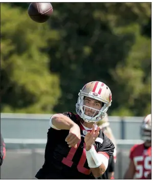  ?? AP/TONY AVELAR ?? San Francisco 49ers quarterbac­k Jimmy Garoppolo runs a drill at the team’s training facility last month in Santa Clara, Calif. Garoppolo is spending part of his summer working with quarterbac­k specialist Tom House.