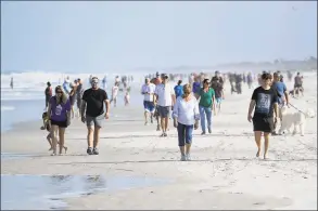  ?? Sam Greenwood / TNS ?? People at a Jacksonvil­le Beach, Fla., beach on April 17 after social distancing restrictio­ns were partially eased.