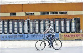  ?? BACHCHAN KUMAR/ HT PHOTO ?? A cyclist rides past a stock of oxygen cylinders arranged at the NMMC-run Covid centre at the Cidco exhibition centre, Vashi, on Thursday.