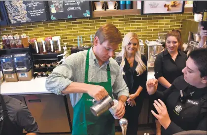  ?? OFFICE OF REP. ERIC SWALWELL ?? Congressma­n Eric Swalwell learns how to pour a latté while working as a barista at a Starbuck’s coffee shop in Dublin on Saturday.