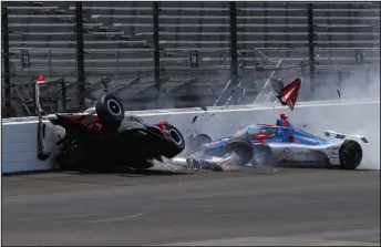  ?? KIRK DEBRUNNER — THE ASSOCIATED PRESS ?? Katherine Legge, of England, left, and Stefan Wilson, of England, crash in the first turn during practice at Indianapol­is Motor Speedway on Tuesday.