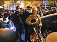  ?? ?? A protester scuffles with police during a rally for the victims of a deadly fire as well as a protest against China’s harsh COVID-19 restrictio­ns in Beijing on Monday.