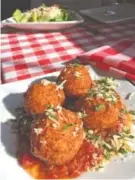  ??  ?? Don’t Go Breaking My Cheese Balls appetizer includes four fried cheese balls made with a threechees­e blend.