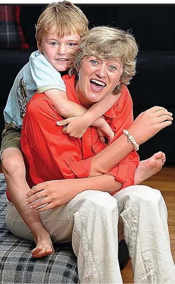  ??  ?? Courage: Corinne Hutton, who lost her hands and lower legs to sepsis, with son Rory