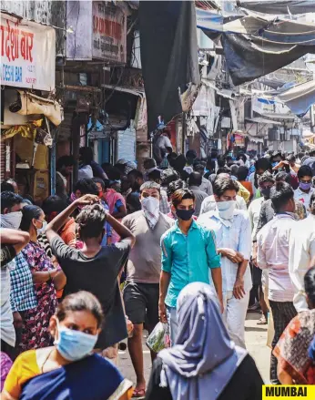  ?? — AFP ?? MUMBAI
People (left) make their way along a lane in the Dharavi slums during a government­imposed nationwide lockdown as a preventive measure against the spread of the Covid-19 on Friday. Worries over Mumbai’s Dharavi emerging as a cluster with a high number of Covid positive cases surged when a 35year-old doctor, who has a clinic in the area, tested positive. This is the third such case which is linked to Dharavi, Asia’s biggest slum. This comes after a 52year old civic worker who worked in Dharavi was tested positive and a 56-year-old who had tested positive for coronaviru­s died on Wednesday.