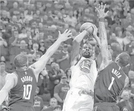  ?? Brett Coomer / Houston Chronicle ?? Even with Rockets defenders’ hands in his face, the Warriors’ Kevin Durant (35) still scored a game-high 34 points, including 5-of-11 on 3-pointers.