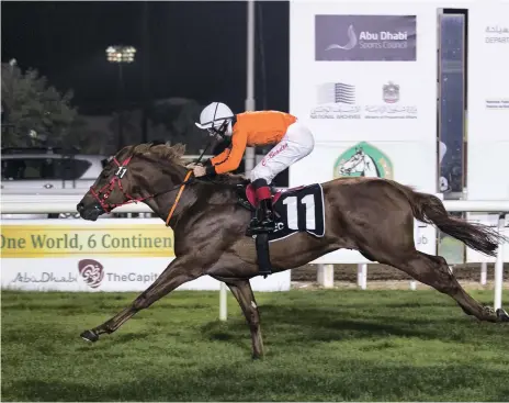  ?? Reem Mohammed / The National ?? Connor Beasley leads Treasured Times across the finish line first in Race 4 in Abu Dhabi