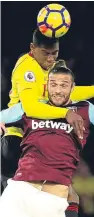  ??  ?? West Ham’s Andy Carroll, bottom, tussles with Christian Kabasele