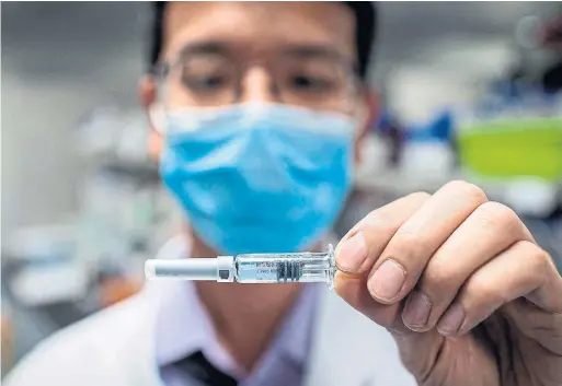  ?? NICOLAS ASFOURI AFP VIA GETTY IMAGES FILE PHOTO ?? Though vaccine candidates have not formally been proven safe, Chinese officials have been injecting them into thousands of people under an emergency use policy.