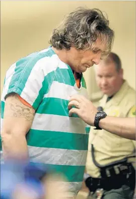  ?? Kent Porter Associated Press ?? DAMIN PASHILK is taken from Lake County Superior Court on Wednesday. He is accused of starting a dozen blazes, including the 4,000-acre Clayton fire.