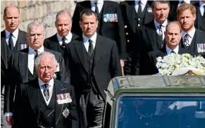  ?? AP ?? Prince Charles follows the coffin as it makes its way past the Round Tower during the funeral of Prince Philip. Also pictured are Prince Andrew, Prince Edward, Prince William, Peter Phillips, Prince Harry, the Earl of Snowdon and Tim Laurence