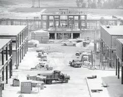  ?? ORLANDO SENTINEL FILE ?? A view of Main Street, U.S.A., in May 1970, looking toward the park’s main railroad station. Old-fashioned facades will turn these steel skeletons into the Magic Kingdom’s iconic Main Street, complete with horse-drawn streetcars and a Penny Arcade.