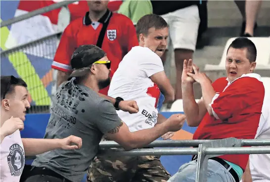  ?? Picture / AP ?? Russian football fans showed their ugly side with attacks on England supporters after their European Championsh­ip match last year.