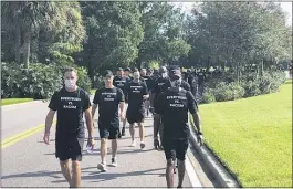  ?? BRIAN MAHONEY — THE ASSOCIATED PRESS ?? NBA referees march in support of players seeking an end to racial injustice in Lake Buena Vista, Fla., on Thursday.