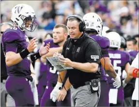  ?? Matt Marton The Associated Press ?? Northweste­rn coach Pat Fitzgerald talks with quarterbac­k Clayton Thorson, left, after an intercepti­on against UNR on Sept. 2 in Evanston, Ill.