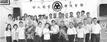  ??  ?? Dr Sim (front row, sixth left) hands over a cheque to a representa­tive of SUPP Lambir branch. With him are (front row, from fourth left) Yii, Lee and Ting and others.