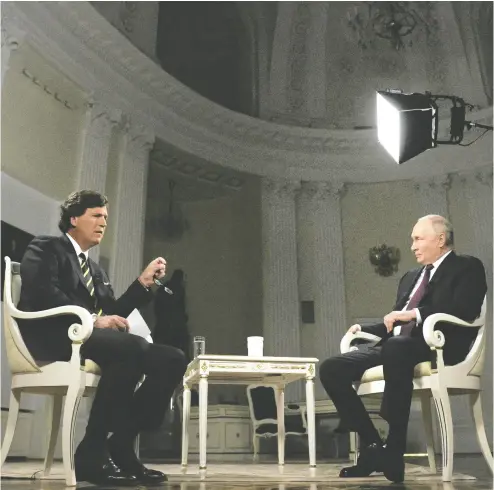  ?? GAVRIIL GRIGOROV /SPUTNIK / KREMLIN POOL PHOTO VIA AP ?? Throughout his interview, Tucker Carlson rarely challenged or fact-checked Russian President Vladimir Putin and often seemed ignorant of basic informatio­n about Eastern European history and geopolitic­s, Adam Zivo writes.