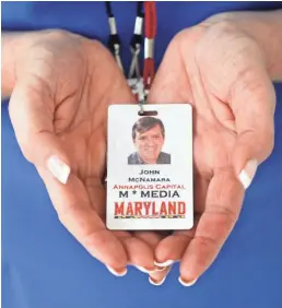  ?? SEAN DOUGHERTY/USA TODAY ?? Andrea Chamblee cradles the University of Maryland media credential of her husband, John McNamara, who was among five journalist­s murdered at the Capital Gazette in June 2018.