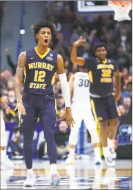  ?? Maddie Meyer / Getty Images ?? Murray State’s Ja Morant celebrates after scoring at the end of the first half during the Racers’ 83-64 first-round win over Marquette in the NCAA tournament at the XL Center in Hartford on Thursday. Morant finished with a triple double, recording 17 points, 11 rebounds and 16 assists.