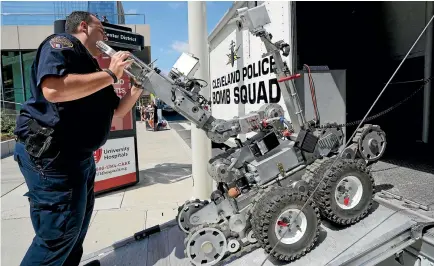  ?? REUTERS ?? A police bomb squad technician unloads a Remotec F5A explosive ordnance device robot during a demonstrat­ion of police capabiliti­es yesterday near the site of the Republican National Convention in Cleveland, Ohio.