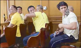  ?? ERNIE PEÑAREDOND­O ?? Former corporal Jumel Cañazares removes his mask as he and six others are sentenced to life imprisonme­nt yesterday for kidnapping a Pakistani-Filipino businessma­n in Makati City in 2007.